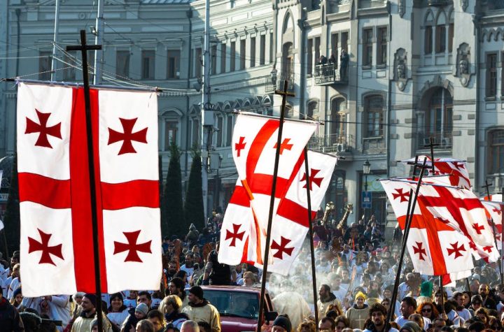 crowd-of-people-waving-flags-of-georgia-during-celebration-of-religious-holiday-on-christmas-day-in